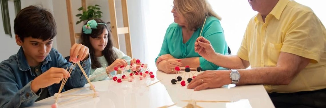 Grandparents and grandchildren engage in a creative building activity indoors.